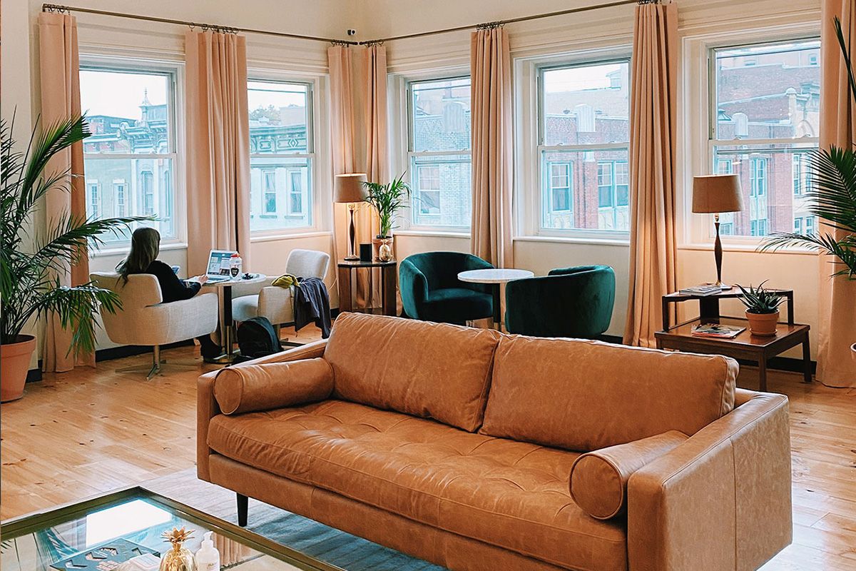 Open loft workspace with arched ceilings and mid-century furnishings